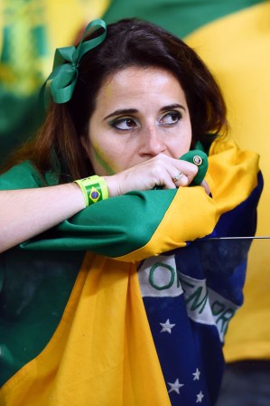 BELO HORIZONTE, BRAZIL - JULY 08: A fan of Brazil shows her dejection during the 2014 FIFA World Cup Brazil Semi Final match between Brazil and Germany at Estadio Mineirao on July 8, 2014 in Belo Horizonte, Brazil. (Photo by Buda Mendes/Getty Images)