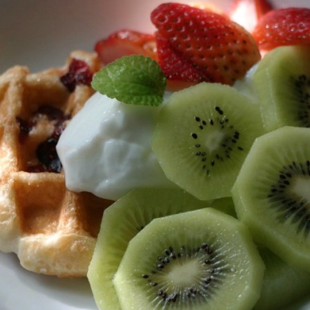Waffle con frutas y yogurt griego.