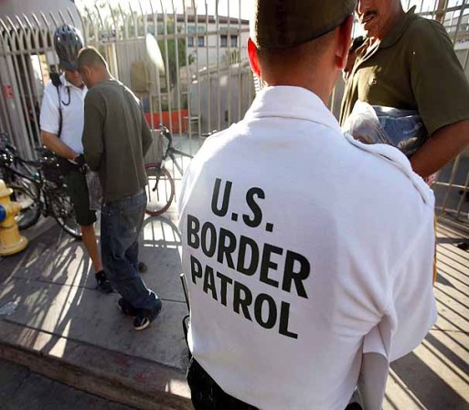 NOGALES, AZ - JUNE 02: An U.S. Customs and Border Protection bike patrol agent assists Mexican's being returned to Mexico after they were apprehended for entering the United States illegally June 2, 2010 in Nogales, Arizona. A fence which separates the cities of Nogales, Arizona and Nogales, Sonora Mexico is a frequent crossing point for people entering the United States illegally. During the 2009 fiscal year 540,865 undocumented immigrants were apprehended entering the United States illegally along the Mexican border, 241,000 of those were captured in the 262 mile stretch of the border known as the Tucson Sector. (Photo by Scott Olson/Getty Images)