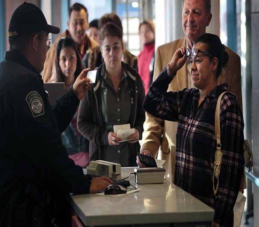 NOGALES, AZ - DECEMBER 10: A U.S. Customs and Border Protection officer checks the IDs of visitors entering the United States from Mexico at the border crossing on December 10, 2010 in Nogales, Arizona. Despite Arizona's tough immigration enforcement laws, thousands of Mexican citizens have permits to work in the U.S. and commute daily from their homes across the border in Mexico. Border crossings, known as "ports of entry," are run by the U.S. Office of Field Operations, which is part of the department of U.S. Customs and Border Protection. Port personnel are the face at the border for most visitors and cargo entering the United States and are authorized to stop, question, search and examine everyone entering the country. (Photo by John Moore/Getty Images)