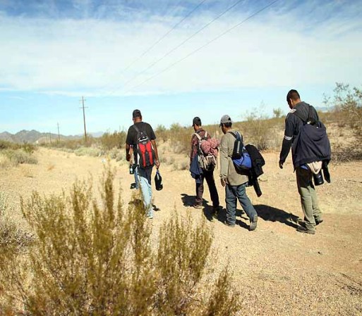 TOHONO O'ODHAM NATION, AZ - JANUARY 19: Undocumented Mexican immigrants walk through the Sonoran Desert after illegally crossing the U.S.-Mexico border border on January 19, 2011 into the Tohono O'odham Nation, Arizona. The immigrants said they had wandered the desert lost for a week after crossing from Mexico into the vast Indian reservation at night. Exhausted, they requested the Border Patrol to pick them up and take them to the U.S.-Mexico border, from where they would return to their homes in the Mexican state of Sonora. They had come, they said, to reach Phoenix and find work in construction or landscaping. All said they had worked in Arizona before. (Photo by John Moore/Getty Images)