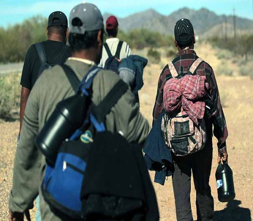 TOHONO O'ODHAM NATION, AZ - JANUARY 19: Undocumented Mexican immigrants walk through the Sonoran Desert after illegally crossing the U.S.-Mexico border border on January 19, 2011 into the Tohono O'odham Nation, Arizona. The immigrants said they had wandered the desert lost for a week after crossing from Mexico into the vast Indian reservation at night. Exhausted, they requested the Border Patrol to pick them up and take them to the U.S.-Mexico border, from where they would return to their homes in the Mexican state of Sonora. They had come, they said, to reach Phoenix and find work in construction or landscaping. All said they had worked in Arizona before. (Photo by John Moore/Getty Images)