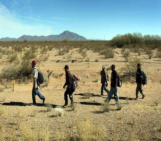 TOHONO O'ODHAM NATION, AZ - JANUARY 19: Undocumented Mexican immigrants walk through the Sonoran Desert after illegally crossing the U.S.-Mexico border border on January 19, 2011 into the Tohono O'odham Nation, Arizona. The immigrants said they had wandered the desert lost for a week after crossing from Mexico into the vast Indian reservation at night. Exhausted, they requested the Border Patrol to pick them up and take them to the U.S.-Mexico border, from where they would return to their homes in the Mexican state of Sonora. They had come, they said, to reach Phoenix and find work in construction or landscaping. All said they had worked in Arizona before. (Photo by John Moore/Getty Images)
