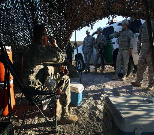 NOGALES, AZ - JUNE 22: U.S. Army National Guardsman Sgt. Brandon Lovato eats a steak for dinner at a Guard post near the U.S.-Mexico border on June 22, 2011 in Nogales, Arizona. The Pentagon recently extended the deployment of some 1,200 guardsmen who were deployed last year to assist with border security on the U.S.-Mexico border until September 30. Soldiers at Early Identification Team (EIT) observation posts in Nogales work 24 hour shifts, each taking turns resting for 4 hours during the night. The National Guard troops are strictly on surveillance duty, although they are armed and have been credited with helping U.S. Border Patrol agents arrest up to 17,000 illegal immigrants crossing into the United States. (Photo by John Moore/Getty Images)