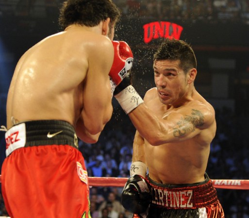 LAS VEGAS, NV - SEPTEMBER 15: Julio Cesar Chavez Jr. takes a punch from Sergio Martinez in the fourth round of their WBC middleweight title fight at the Thomas & Mack Center on September 15, 2012 in Las Vegas, Nevada. (Photo by Jeff Bottari/Getty Images)