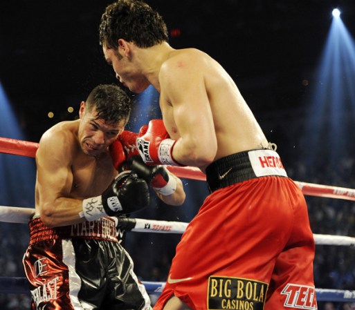 LAS VEGAS, NV - SEPTEMBER 15: Julio Cesar Chavez Jr. (R) lands a right to the head of Sergio Martinez in the seventh round of their WBC middleweight title fight at the Thomas & Mack Center on September 15, 2012 in Las Vegas, Nevada. (Photo by Jeff Bottari/Getty Images)