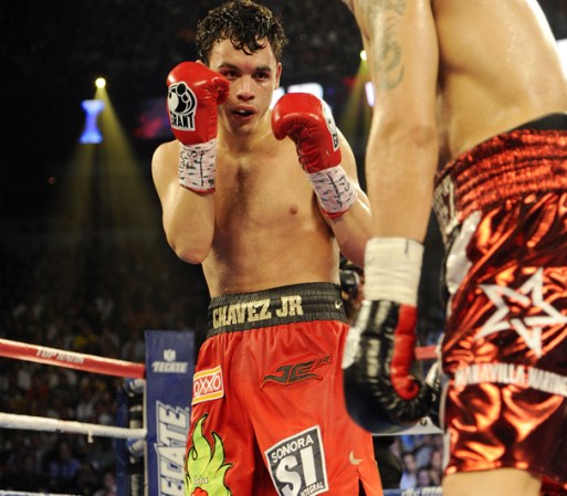 LAS VEGAS, NV - SEPTEMBER 15: Julio Cesar Chavez Jr. (L) and Sergio Martinez trade punches in the seventh round of their WBC middleweight title fight at the Thomas & Mack Center on September 15, 2012 in Las Vegas, Nevada. (Photo by Jeff Bottari/Getty Images)