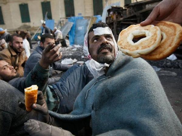 FEBRERO, 2011: Un manifestante anti Mubarak se alimenta como puede en la plaza Tahir.
