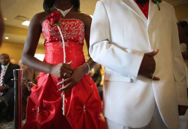 WEST PALM BEACH, FL - FEBRUARY 14: Shanika Young and Robert Young (L-R) stand together as they are wed during a group Valentine's day wedding at the National Croquet Center on February 14, 2013 in West Palm Beach, Florida. The group wedding ceremony is put on by the Palm Beach Country Clerk & Comptroller's office and approximately 40 couples tied the knot. (Photo by Joe Raedle/Getty Images)