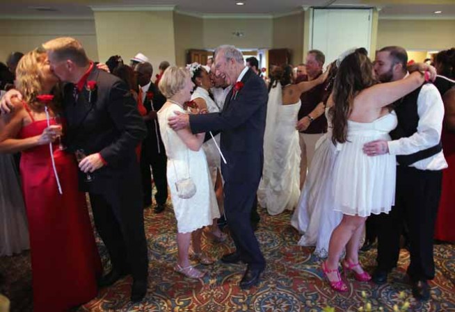 WEST PALM BEACH, FL - FEBRUARY 14: (L-R) Karen Brown, Douglas Brown, Arlene Joseph, Stuart Joseph, Ashley Homa and Robert Homa all newly weds celebrate after being wed during a group Valentine's day wedding at the National Croquet Center on February 14, 2013 in West Palm Beach, Florida. The group wedding ceremony is put on by the Palm Beach Country Clerk & Comptroller's office and approximately 40 couples to tied the knot. (Photo by Joe Raedle/Getty Images)