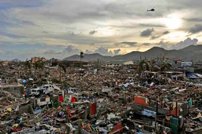 TACLOBAN, PHILIPPINES - NOVEMBER 13: An entire neighbourhood is destroyed in the aftermath of Typhoon Haiyan on November 13, 2013 in Tacloban, Leyte, Philippines. Typhoon Haiyan, packing maximum sustained winds of 195 mph (315 kph), slammed into the southern Philippines and left a trail of destruction in multiple provinces, forcing hundreds of thousands to evacuate and making travel by air and land to hard-hit provinces difficult. Around 10,000 people are feared dead in the strongest typhoon to hit the Philippines this year. (Photo by Kevin Frayer/Getty Images)
