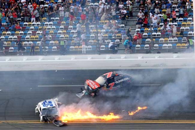 DAYTONA BEACH, FL - FEBRUARY 23: Kyle Larson, driver of the #32 Clorox Chevrolet, and Regan Smith, driver of the #7 Clean Coal Chevrolet, are involved in an incident at the finish of the NASCAR Nationwide Series DRIVE4COPD 300 at Daytona International Speedway on February 23, 2013 in Daytona Beach, Florida. (Photo by Matthew Stockman/Getty Images)