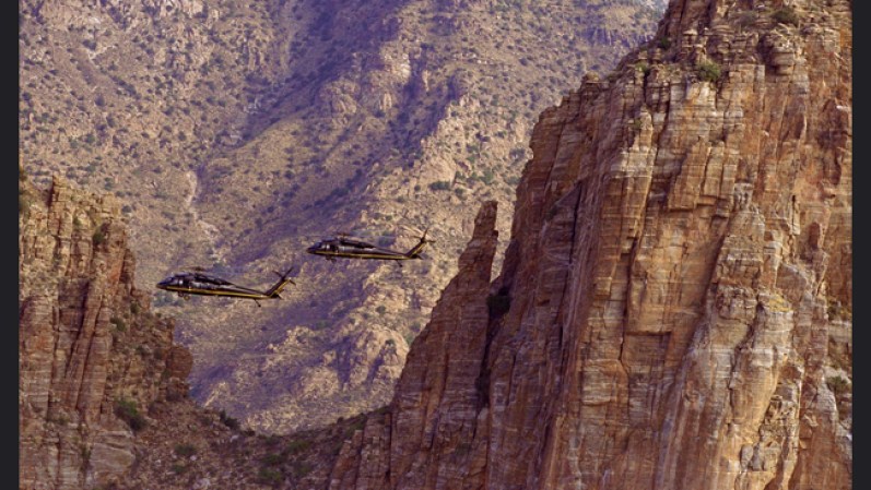 En el desierto de Arizona, los helicópteros patrullan las zonas montañosas buscando grupos que ya han cruzado la frontera.