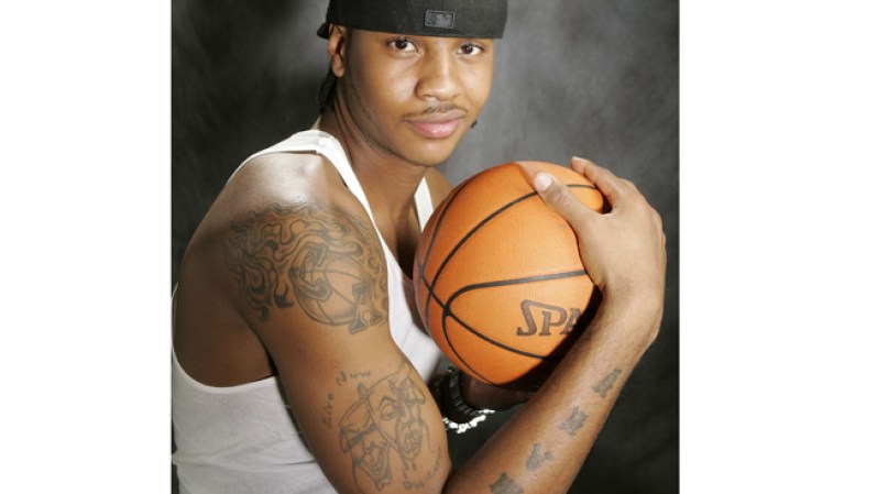 Entre los tatuajes que luce el jugador de la NBA Carmelo Anthony en su brazo derecho están un canasto en llamas con sus iniciales CA, así como las caritas de “sonríe ahora y llora después”, pero con una daga en la frente de la cara llorando.
