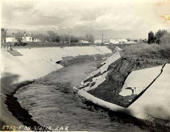 This 1938 image shows the LA River just before it receives the Tujunga Wash. By 1938, some portions of the river had been channelized (lined in concrete). The flood waters managed to rip away concrete siding from this portion of the river.