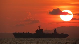 Navy vessel at sea at sunset