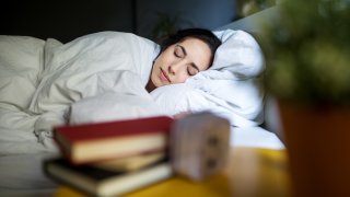 Young woman sleeping peacefully on her bed at homeYoung woman sleeping peacefully on her bed at home