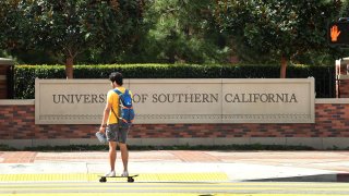 A skateboarder commutes at the University of Southern California.