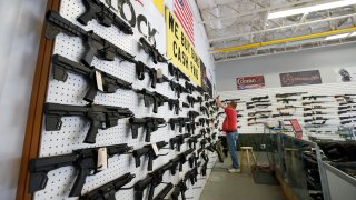 a worker restocks AR-15 guns