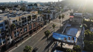 An aerial view shows light traffic passing on Sunset Boulevard in Los Angeles on April 15, 2020.