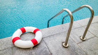 Life ring at swimming pool.emergency tire floating at swimming pool.