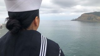 Sailor looks at San Diego coastline