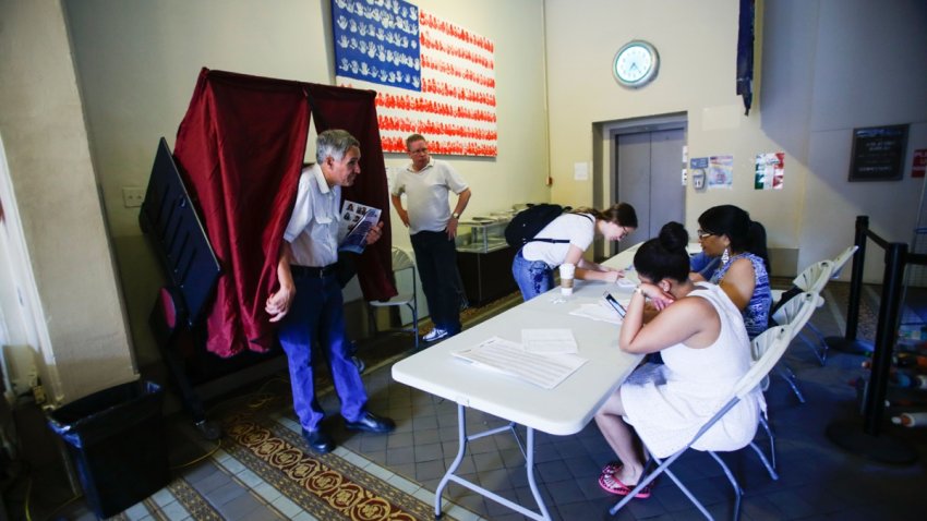 A man exits a booth after casting his ballot at polling station during New Jersey’s primary elections on June 7, 2016 in Hoboken, New Jersey.