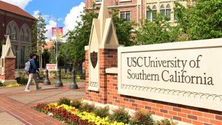 A student wears a facemask at the University of Southern California (USC) in Los Angeles, California on March 11, 2020, where a number of southern California universities, including USC, have suspended in-person classes due to coronavirus concerns.