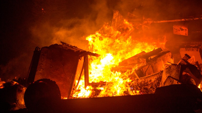 A recreational vehicle is consumed by the Bobcat Fire in Juniper Hills, Calif., Friday, Sept. 18, 2020.