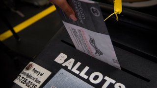 A woman casts her ballot.