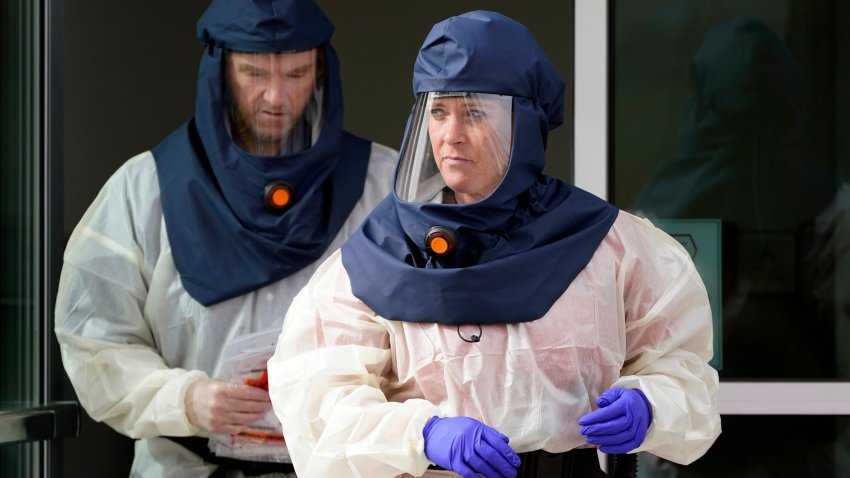 Salt Lake County Health Department public health nurses look on during coronavirus testing outside the Salt Lake County Health Department in Salt Lake City