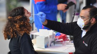 In this Oct. 8, 2020, file photo, a medical worker takes a nasal swab sample from a student to test for COVID-19 at the Brooklyn Health Medical Alliance urgent care pop up testing site as infection rates spike in New York City.