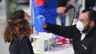 In this Oct. 8, 2020, file photo, a medical worker takes a nasal swab sample from a student to test for COVID-19 at the Brooklyn Health Medical Alliance urgent care pop up testing site as infection rates spike in New York City.