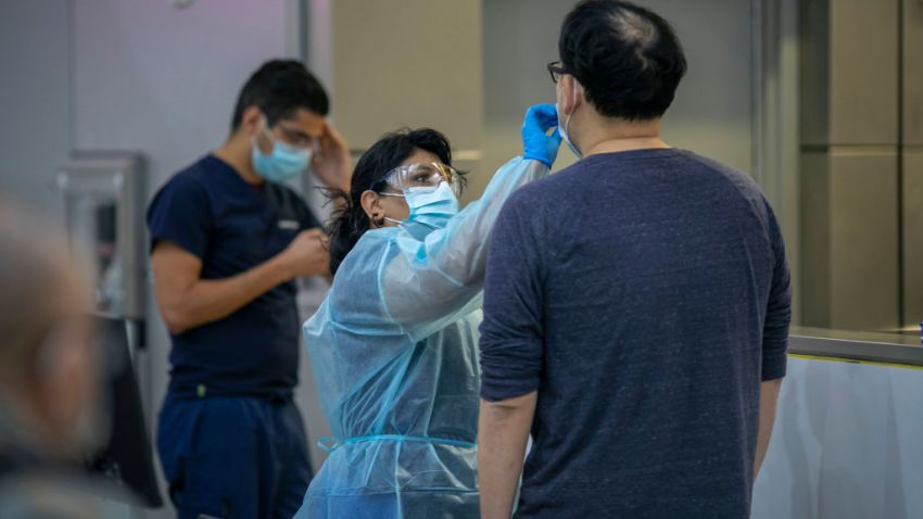 In this Nov. 25, 2020, file photo, a traveler is tested COVID-19 at LAX Tom Bradley International Terminal on Thanksgiving eve as the coronavirus spike worsens and stay-at-home restrictions are increased in Los Angeles, California.