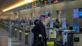 International travelers pass through a nearly empty LAX Tom Bradley International Terminal.