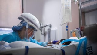 In this Jan. 3, 2021, file photo, registered nurse Yeni Sandoval wears personal protective equipment (PPE) while she cares for a COVID-19 patient in the Intensive Care Unit (ICU) at Providence Cedars-Sinai Tarzana Medical Center in Tarzana, California.