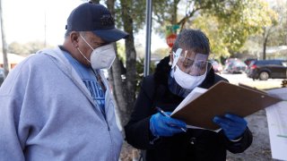 In this Jan. 10, 2021, file photo, residents wait in line to receive the COVID-19 vaccine at St. Johns Missionary Baptist Church in Tampa, Florida.