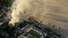 Thick smoke drifts over Venice Beach, where a fire burned a commercial building.