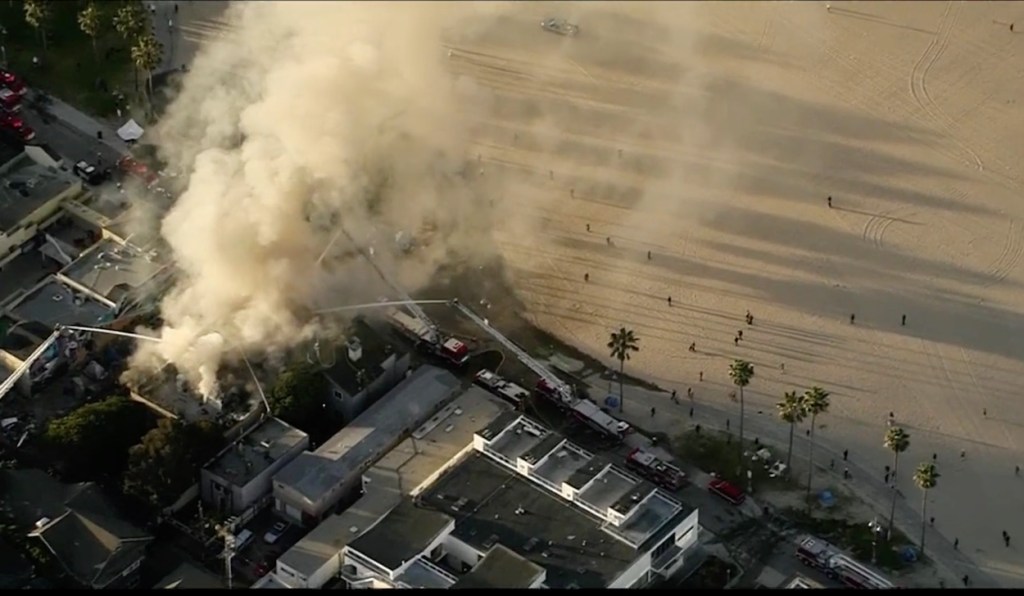 Thick smoke drifts over Venice Beach, where a fire burned a commercial building.
