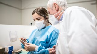 Nurse prepares doses of Covid-19 vaccine.