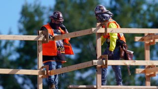 Construction workers talk at a USA Properties Fund site