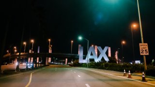 LAX gateway pylons illuminate amber.