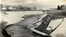 This 1938 image shows the LA River just before it receives the Tujunga Wash. By 1938, some portions of the river had been channelized (lined in concrete). The flood waters managed to rip away concrete siding from this portion of the river.