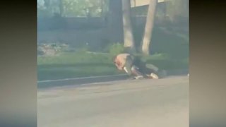 A still from a video shows two Los Angeles County Sheriff's deputies struggling with a package theft suspect in Canyon Country