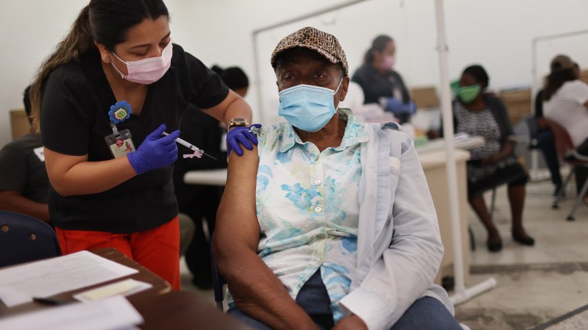 Anna Mendez, LPN, administers a Moderna COVID-19 vaccine to Vern Henderson at a clinic set up by Healthcare Network on May 20, 2021 in Immokalee, Florida.