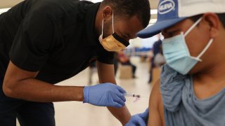Medical assistant administers the COVID-19 vaccine.