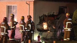 Firefighters at the scene of a SUV crash in Baldwin Hills.