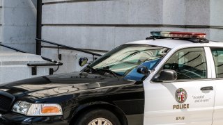 An LAPD patrol car parked in front of City Hall.