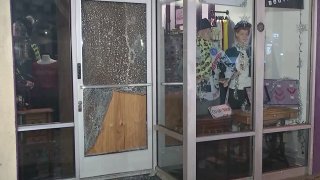 A shattered glass door is pictured after robberies in Burbank.