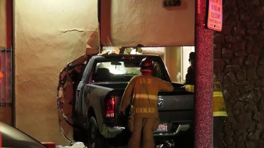 A pickup truck driver slammed into the wall of a Long Beach home, injuring a child before taking off on foot.